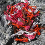 Wire coils (white, orange, pink, brown) for Michele's Fab 40 Basket, taken on a lichen-covered rock at Mt Bowes in Tasmania.