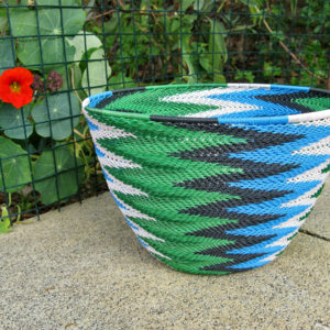 Telephone wire basket in a chevron pattern using bright blue, black, white, light green and dark green wires.
