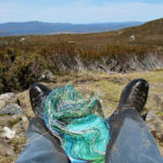 Telephone wire basket in progress, with a view of the Cradle Mountain - Lake St Clair National Park in the distance.