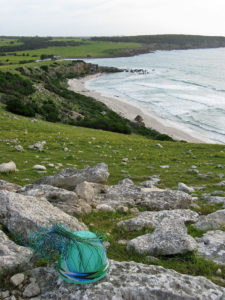 Wire basket on the hilltops looking down to Stokes Bay beach, Kangaroo Island.